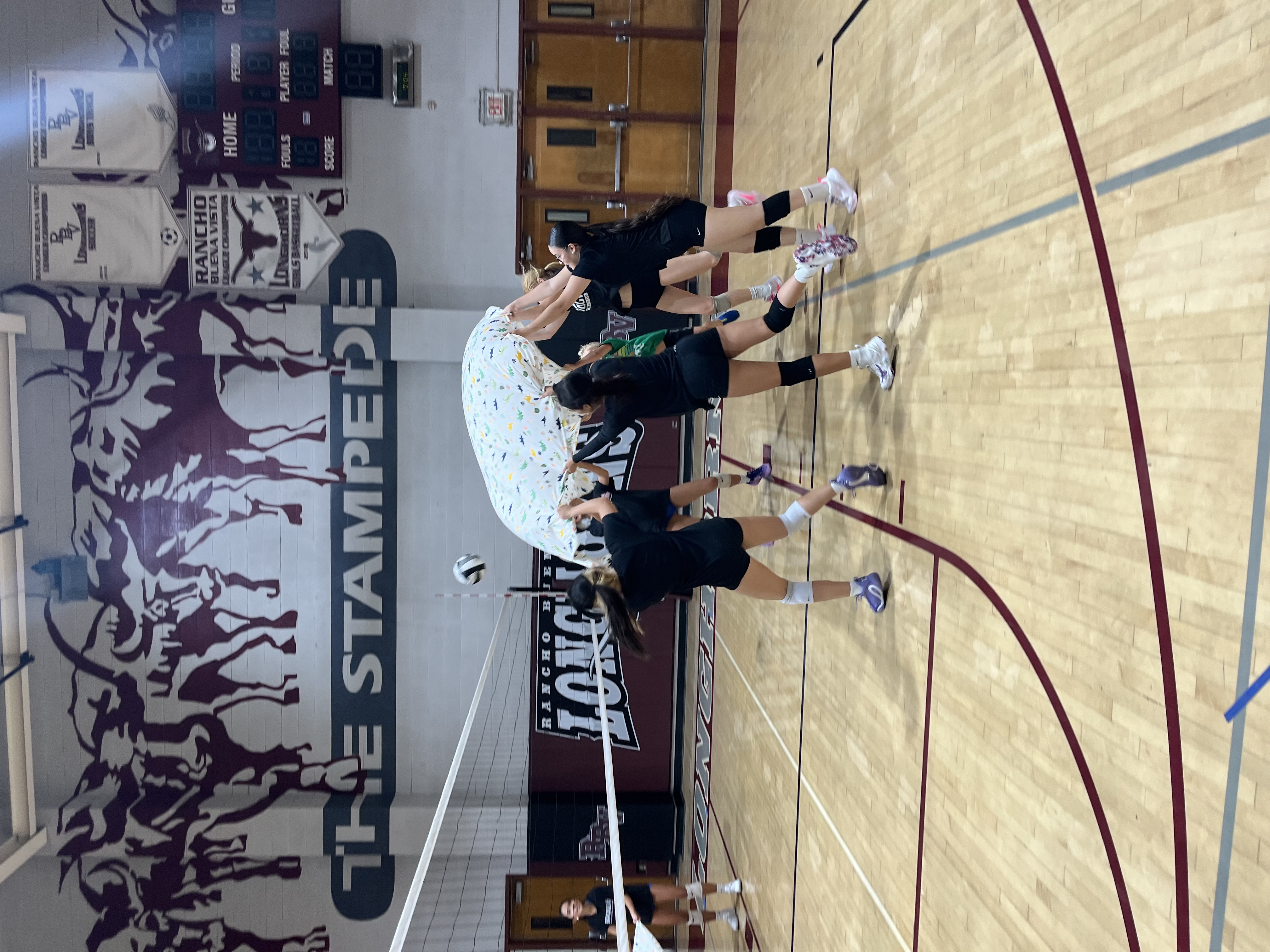 RBV volleyball team celebrating during glow practice