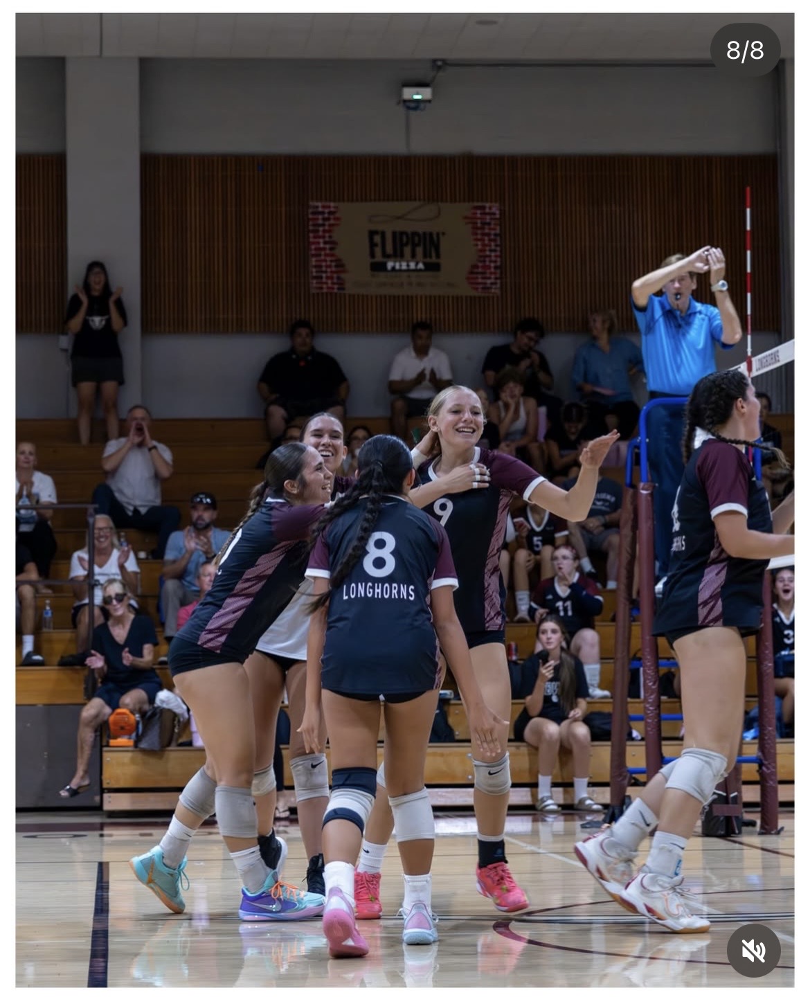 RBV varsity volleyball players celebrating together during the LCC match